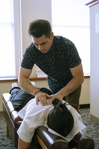 Chiropractor Portland OR Reyn Johnson Adjusting Back Patient
