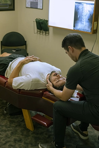 Chiropractor Portland OR Reyn Johnson Adjusting Male Neck Patient
