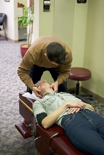 Chiropractor Portland OR Reyn Johnson Adjusting Neck Patient